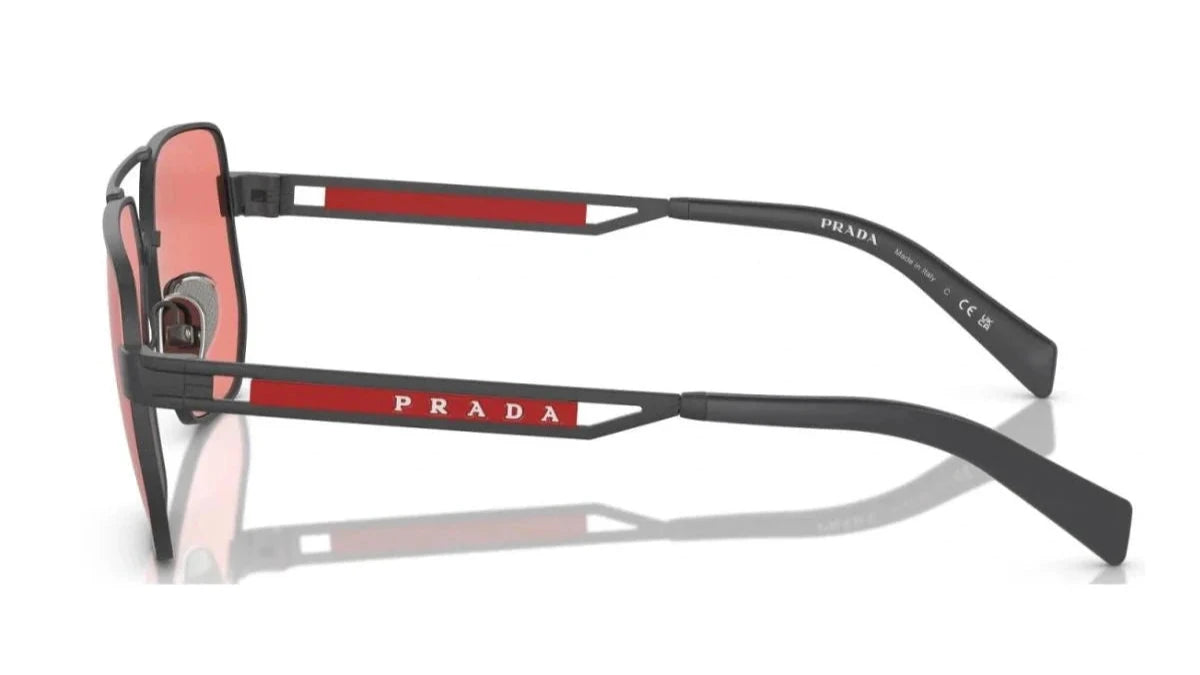 Close-up of the side profile showcasing Prada branding and red accent details on the temples.