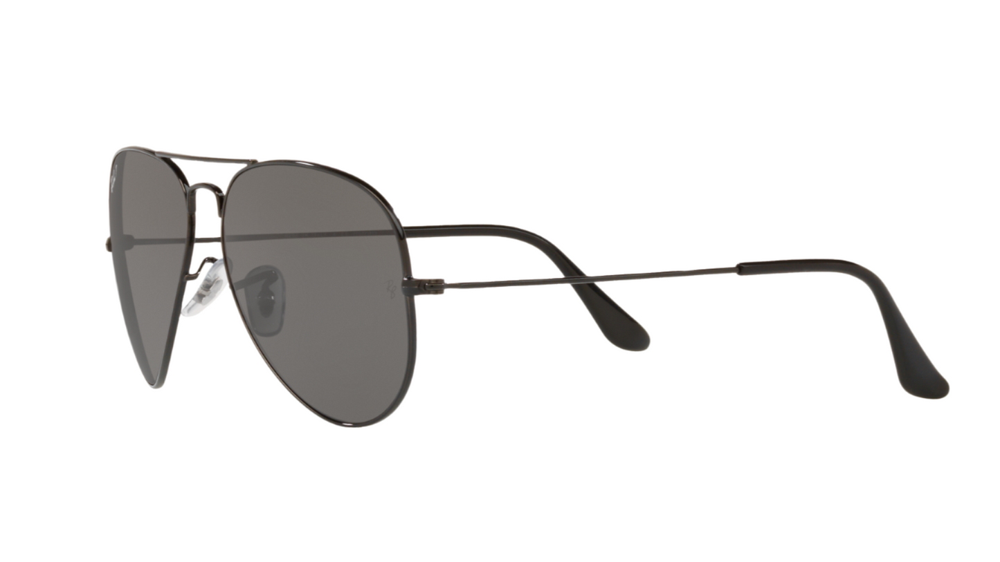 Sunglasses with dark lenses and thin metal frame on a white background