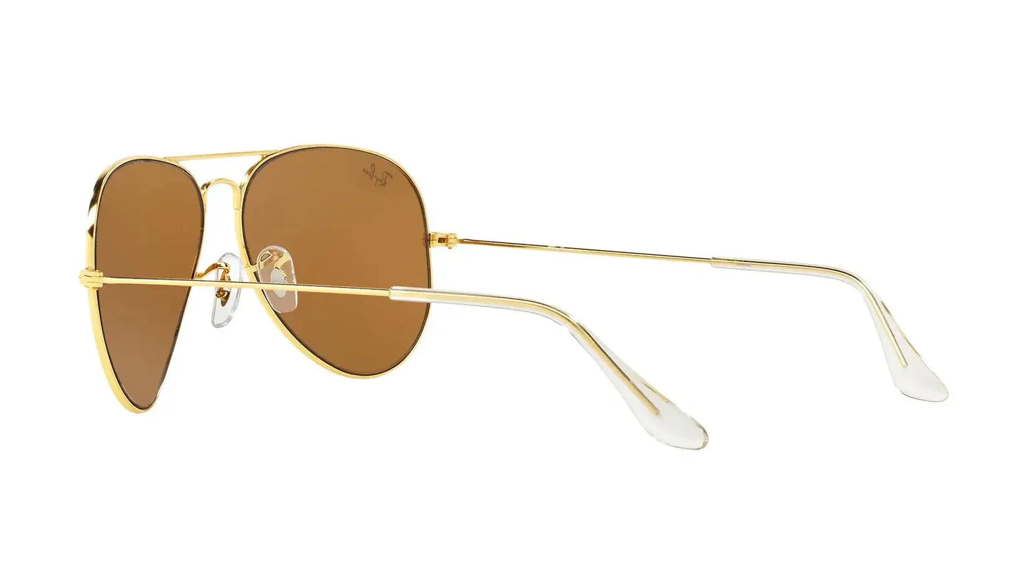"Ray-Ban Aviator Classic sunglasses with a gold metal frame and brown gradient lenses, featuring a teardrop shape and thin temples, designed for unisex wear.