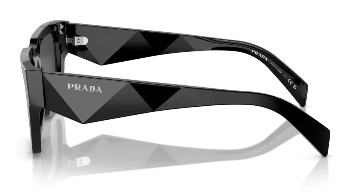 Side view of PRADA SPR A06 16K 08Z sunglasses showcasing black geometric temples with the Prada logo.