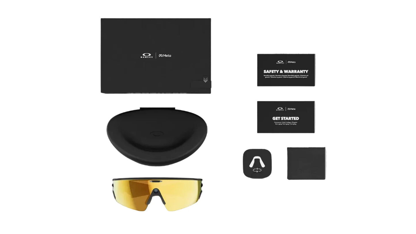 Safety glasses with black case, warranty card, and branded box on a white background