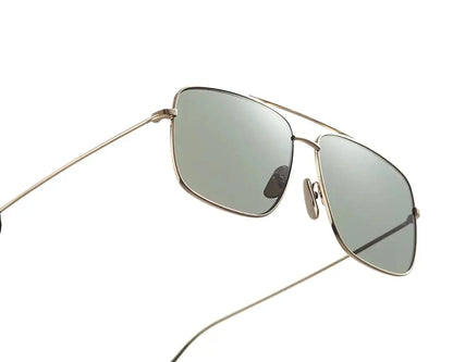 Aviator-style sunglasses with a sleek metal frame and gradient brown lenses. The design features a double bridge and thin arms with brown-tipped earpieces, giving them a classic and timeless look. The lenses transition smoothly from dark to light, adding a stylish flair while providing sun protection.