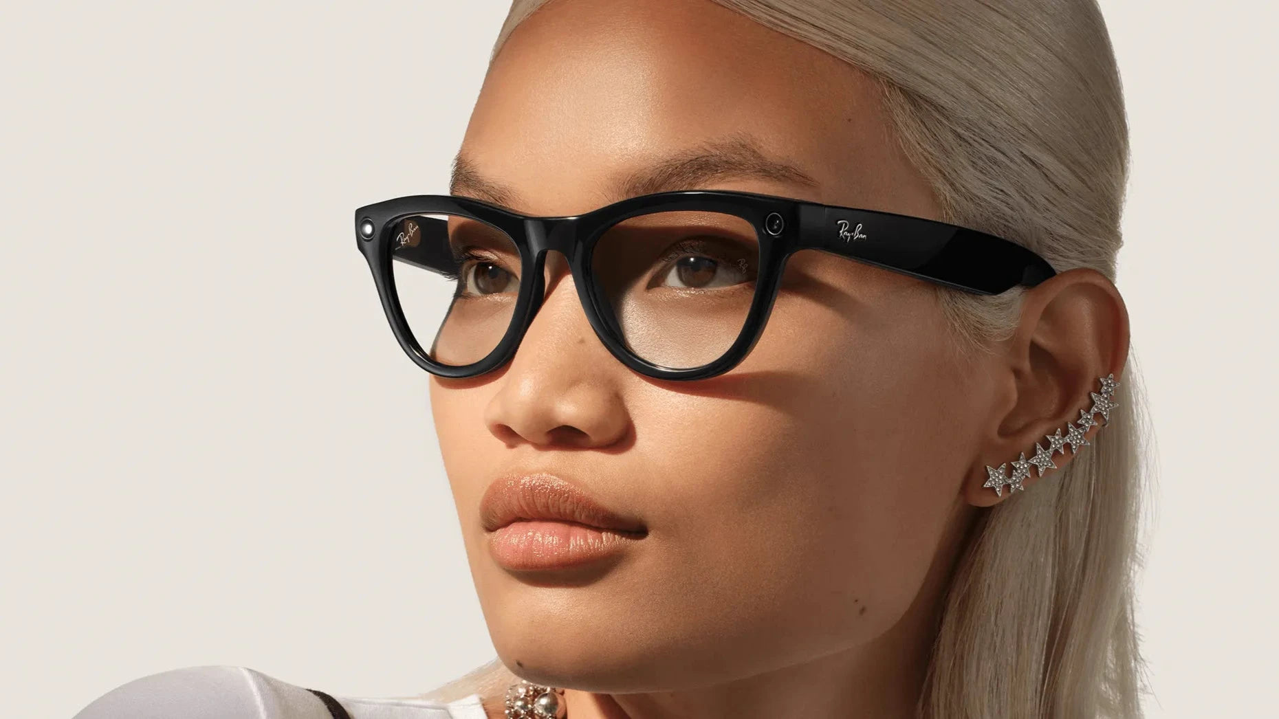 Woman wearing black Ray-Ban Meta Skyler cat-eye glasses with a neutral background