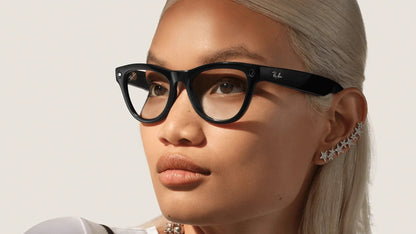 Woman wearing black Ray-Ban Meta Skyler cat-eye glasses with a neutral background