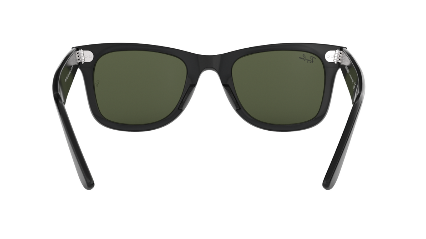 Black sunglasses with green lenses on a white background