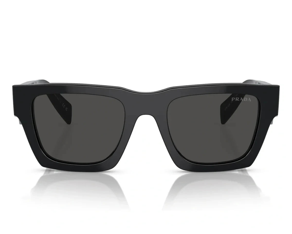 Front-facing view of PRADA SPR A06 16K 08Z sunglasses with dark lenses and sharp, structured edges.